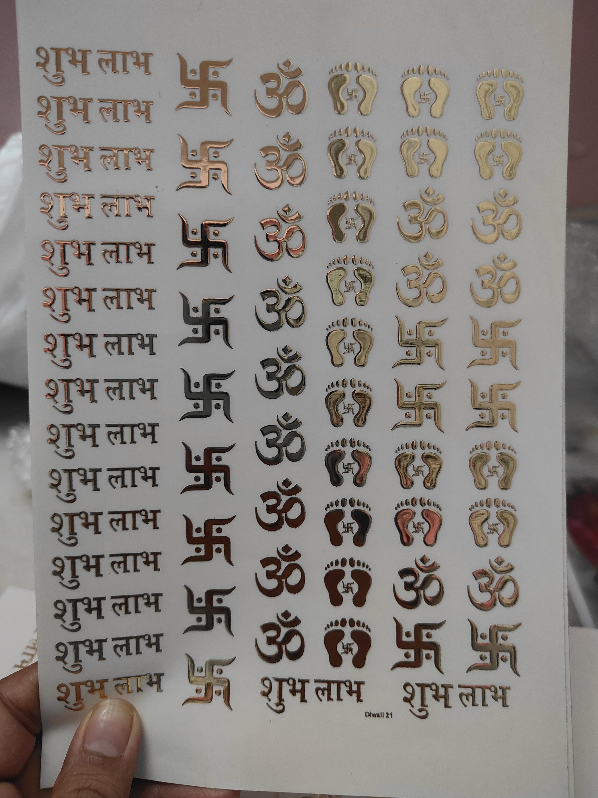 Gold embossed symbol sticker sheet with repeated small icons