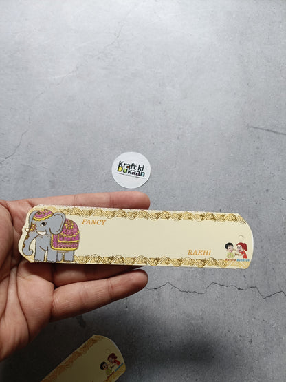 Held A9 Rakhi card, pack of 12, gold border with elephant and kids icons, 'Rakhi'.