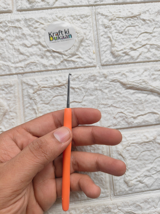 Knitting needle with orange handle and silver metal tip