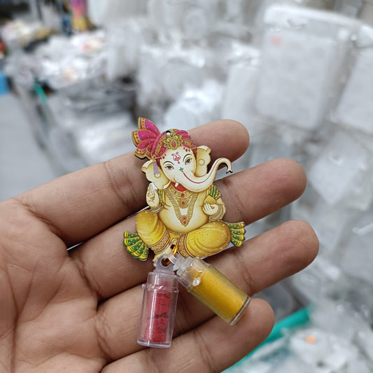 Ganesha-themed haldi-kumkum bottle with yellow dispenser and pink powder vial