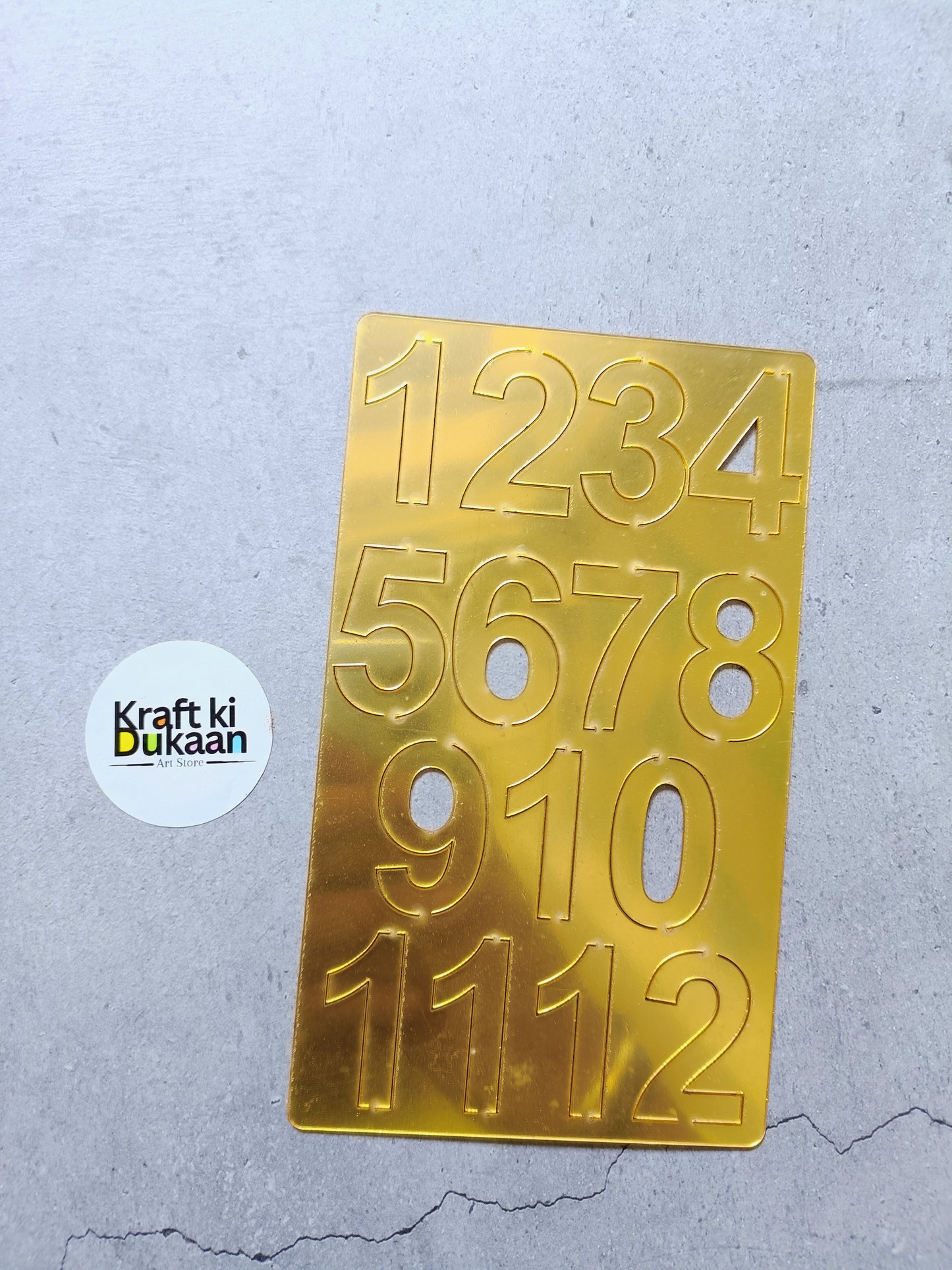 Gold acrylic number tile with raised digits 0–12 and 1234–5678