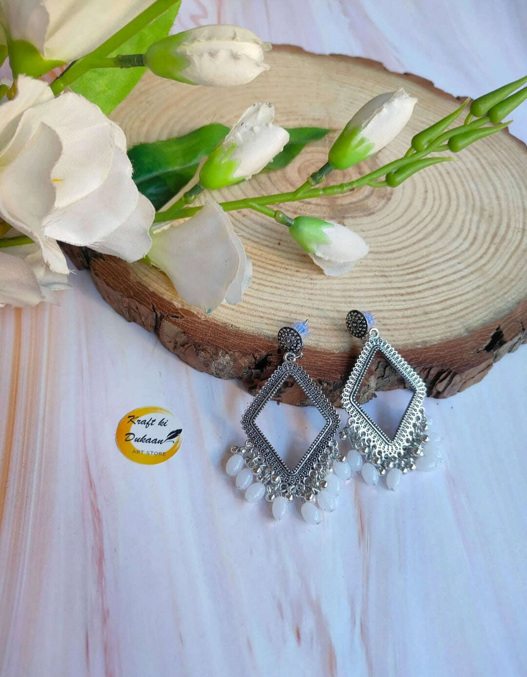 Silver rhombus jhumka with white bead fringe drops
