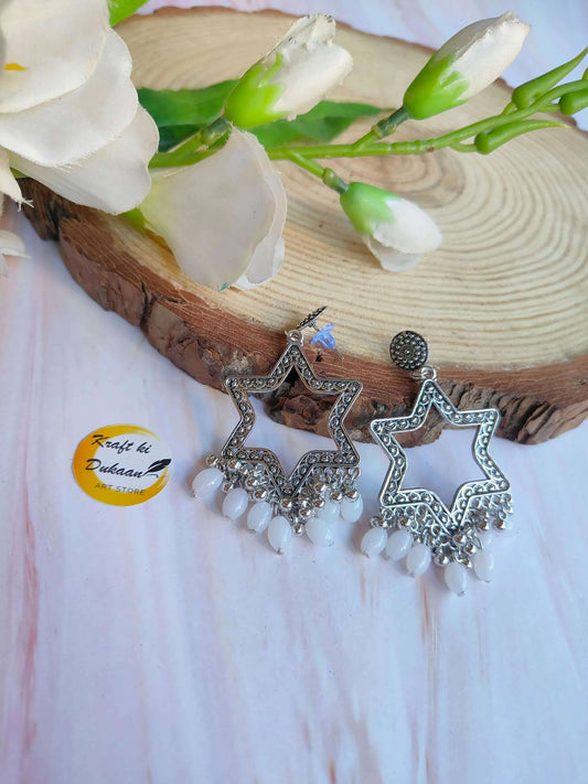 Star Jhumka with white bead fringe and silver tone star-shaped danglers