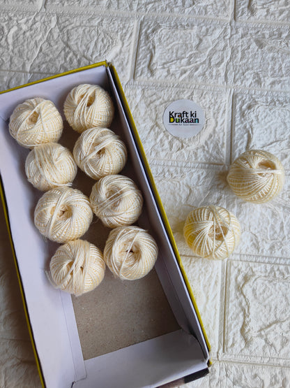 Rakhi thread roll with off-white thread balls in open box and loose balls