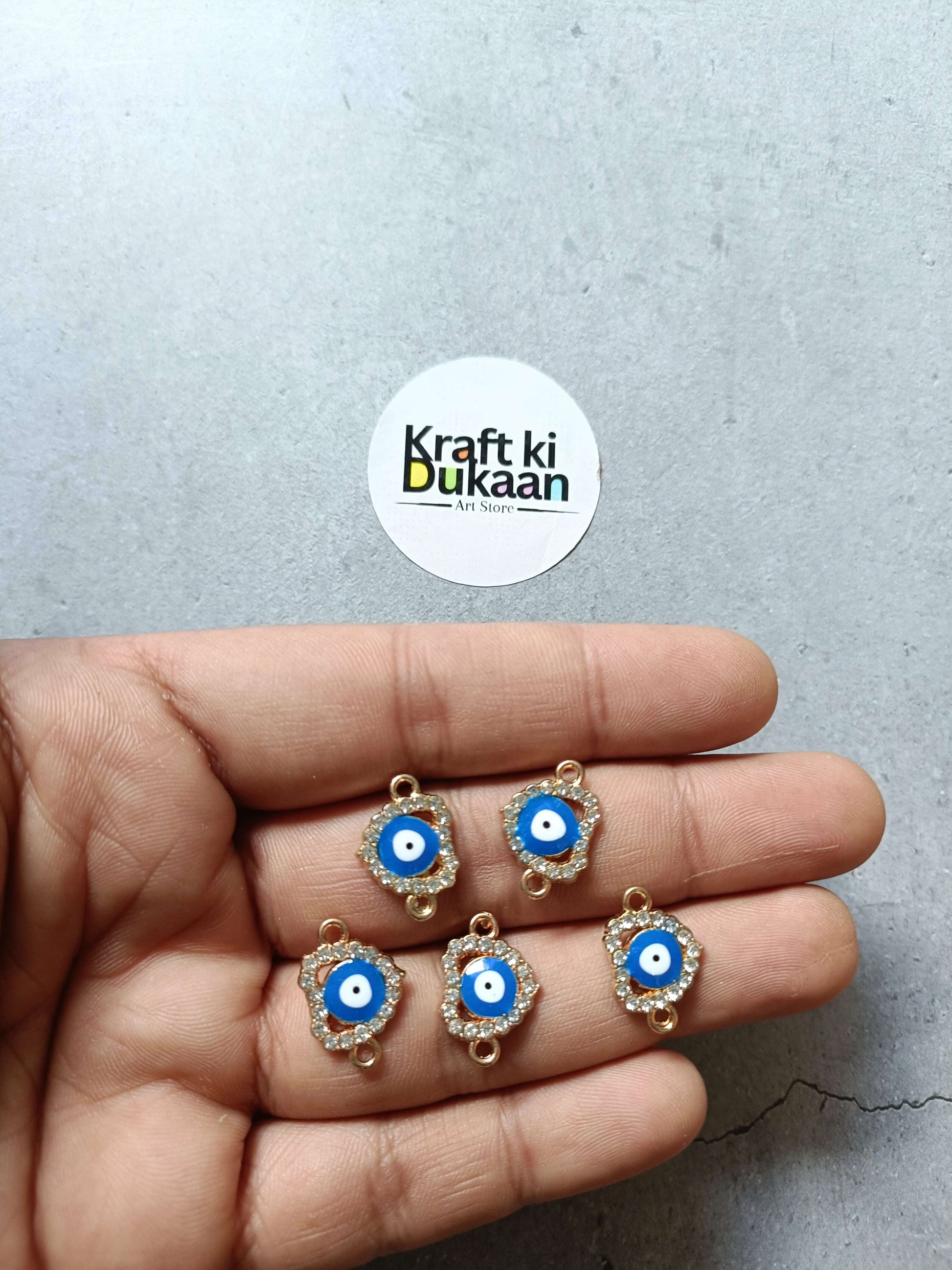 Set of five evil eye bracelet charms with blue enamel and gold-tone frames