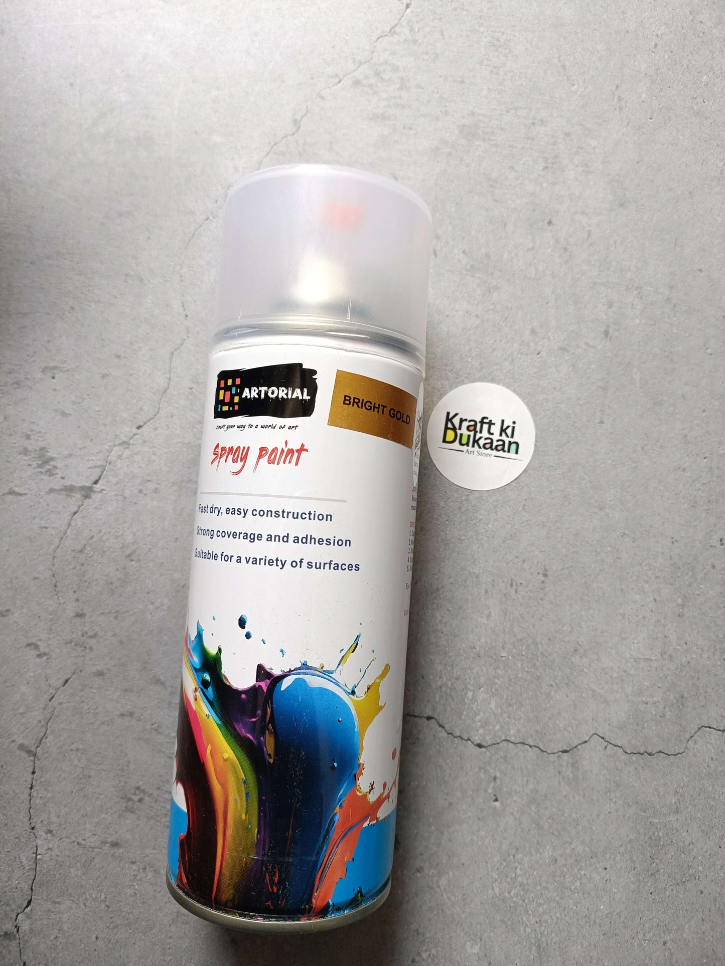 Bright gold spray paint can standing with “Kraft ki Dukaan” sticker on the side