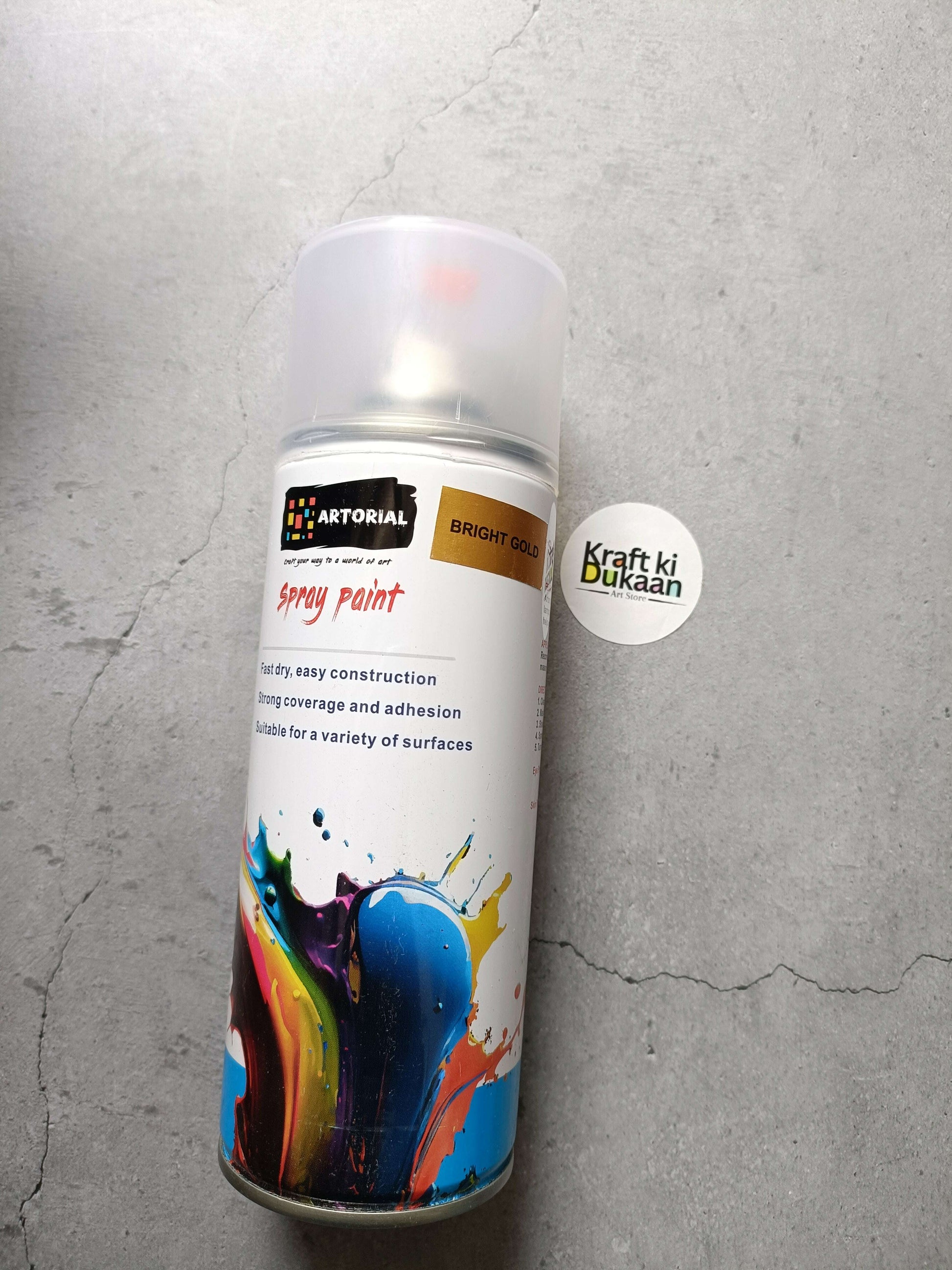 Bright gold spray paint can standing with “Kraft ki Dukaan” sticker on the side