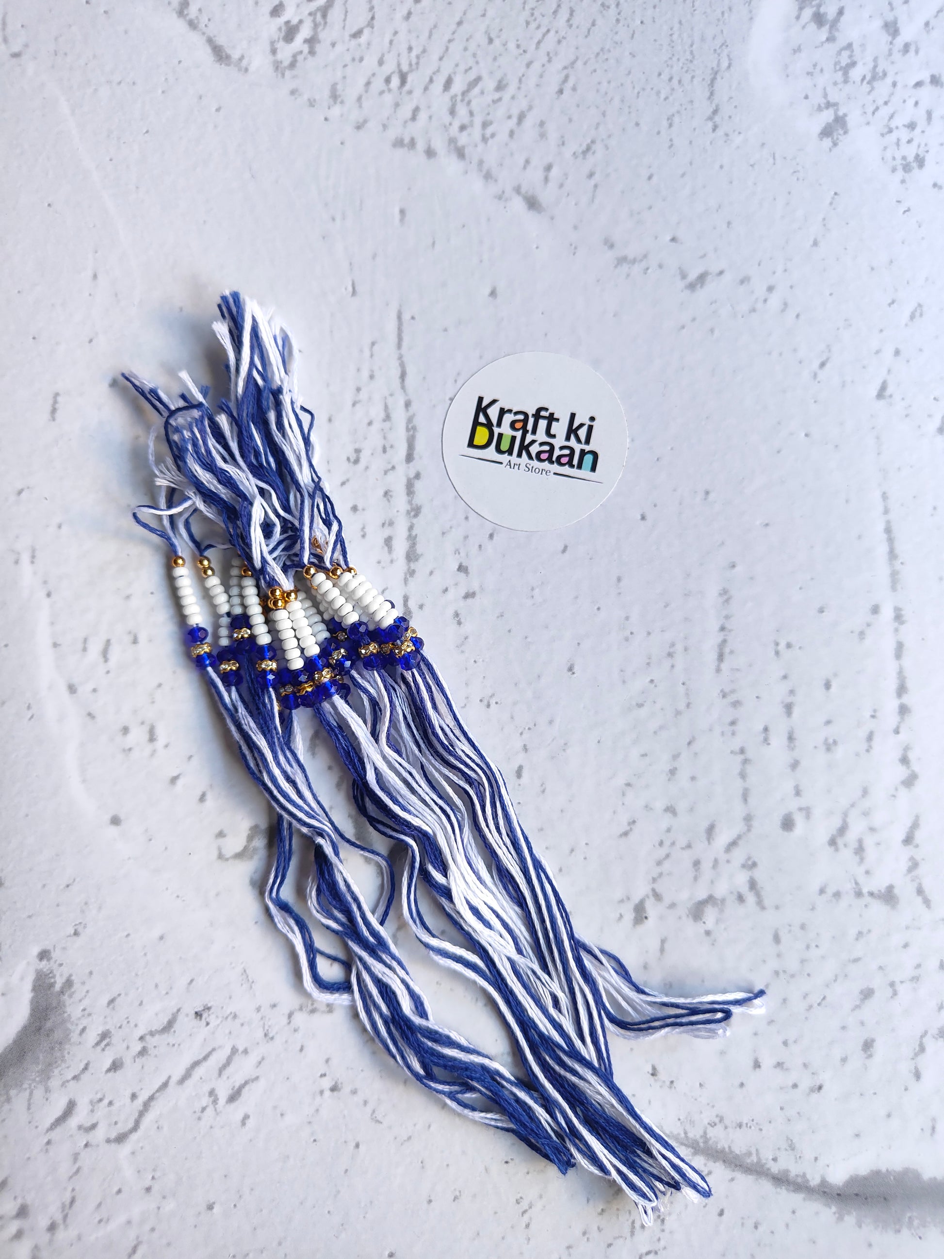 Rakhi dori set with blue braided threads and gold bead accents, pack of 12