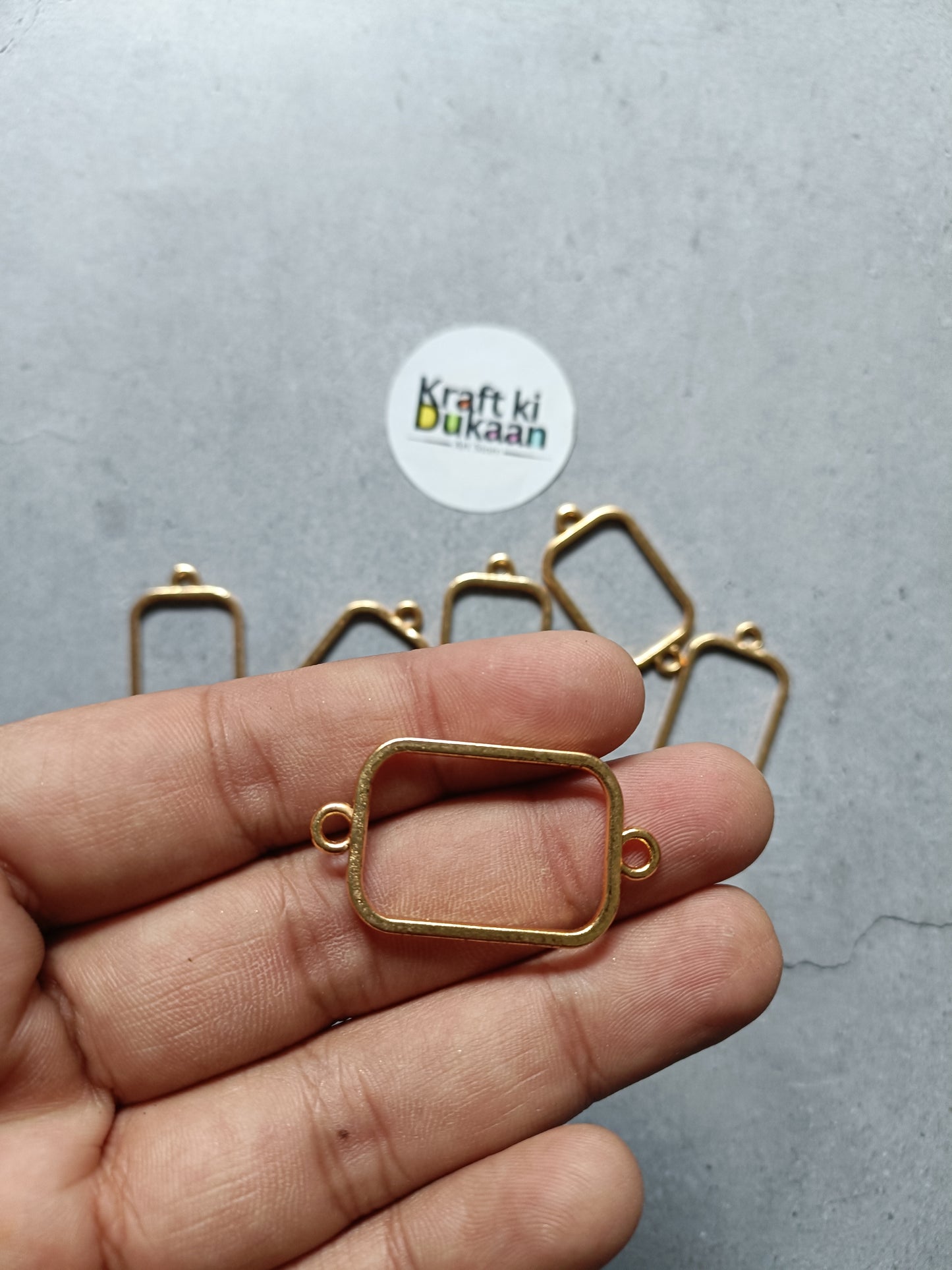 Rectangle bracelet bezel frame, curved plain setting, gold tone, held in hand