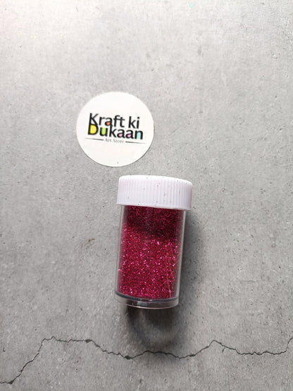 Fuchsia chunky glitter powder in clear shaker bottle with white lid