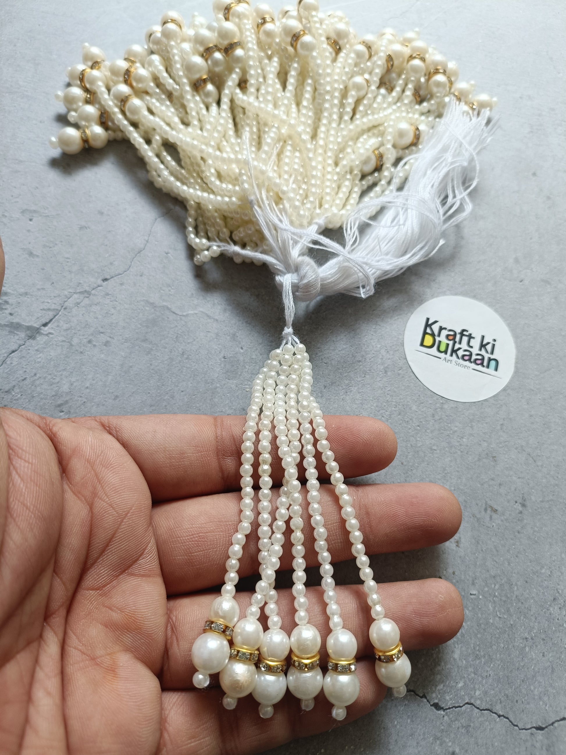 Pearl bead tassel earring with round drops and small gold-tone accents