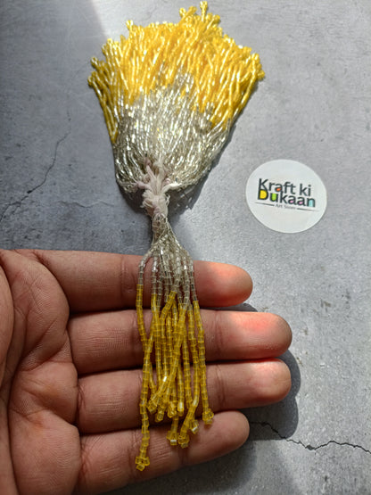 Small beaded tassel latkan with silver top and yellow fringe.