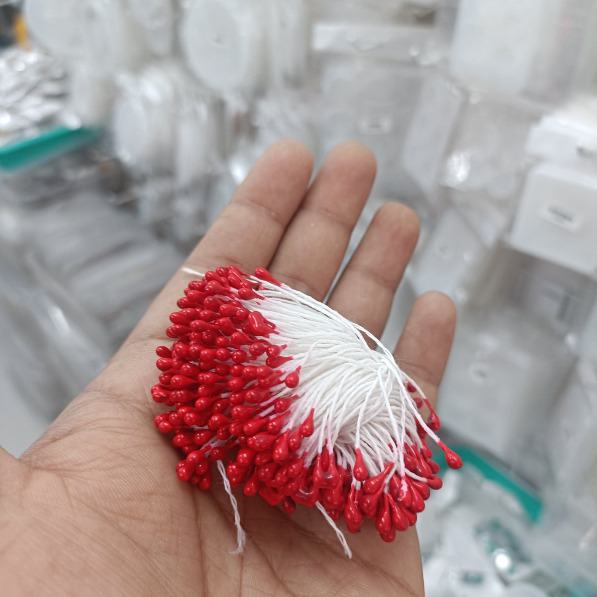 Artificial pollen bunch, red bead-like tips with white filament stems