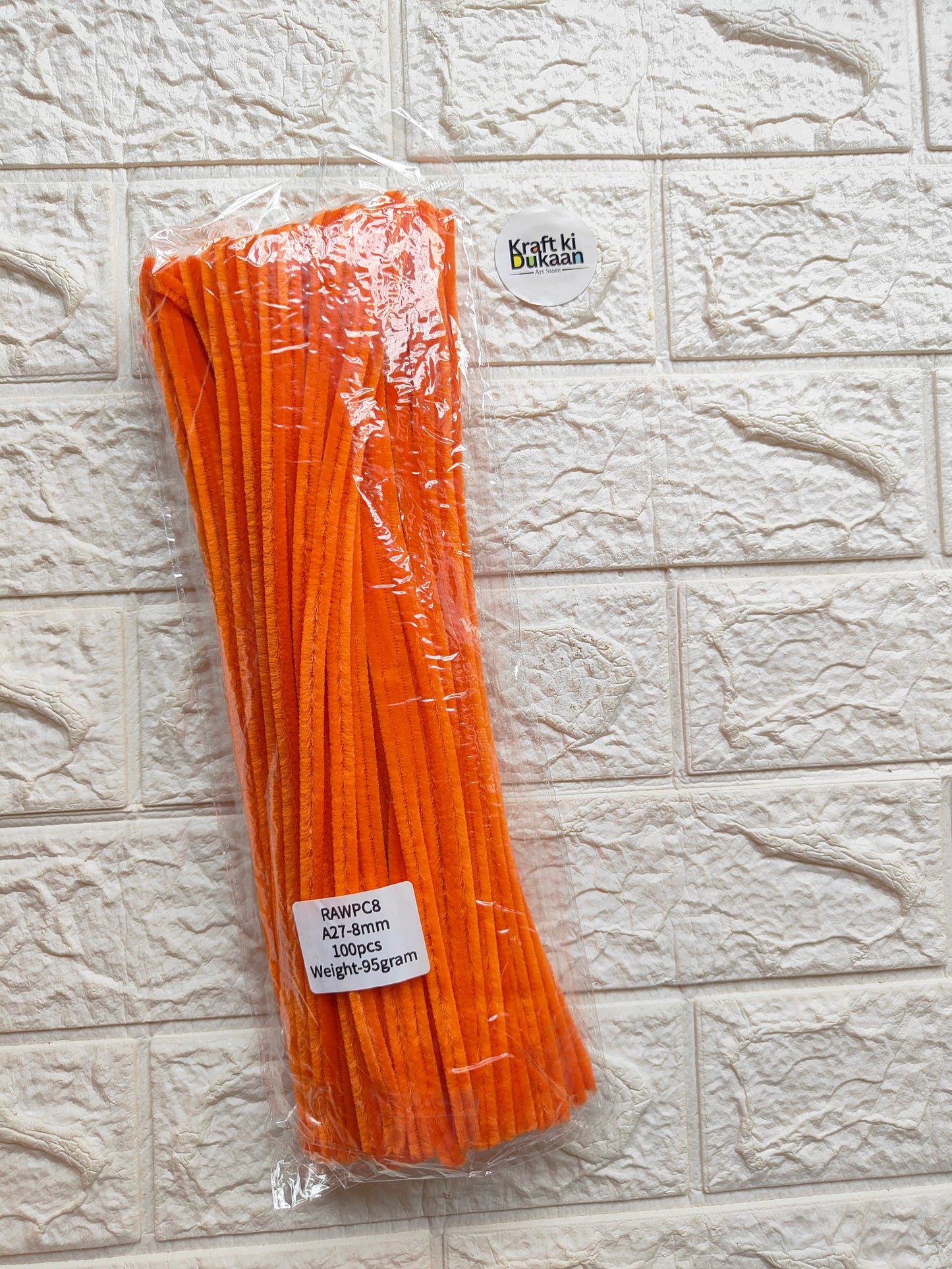 Orange pipe cleaners, 8mm stems, in clear plastic packaging with label
