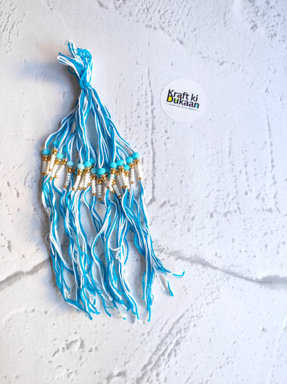 Blue rakhi thread tassel with gold and white bead accents, pack of 12