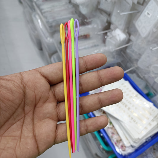 Set of five crochet needles in assorted colors, shown on hand