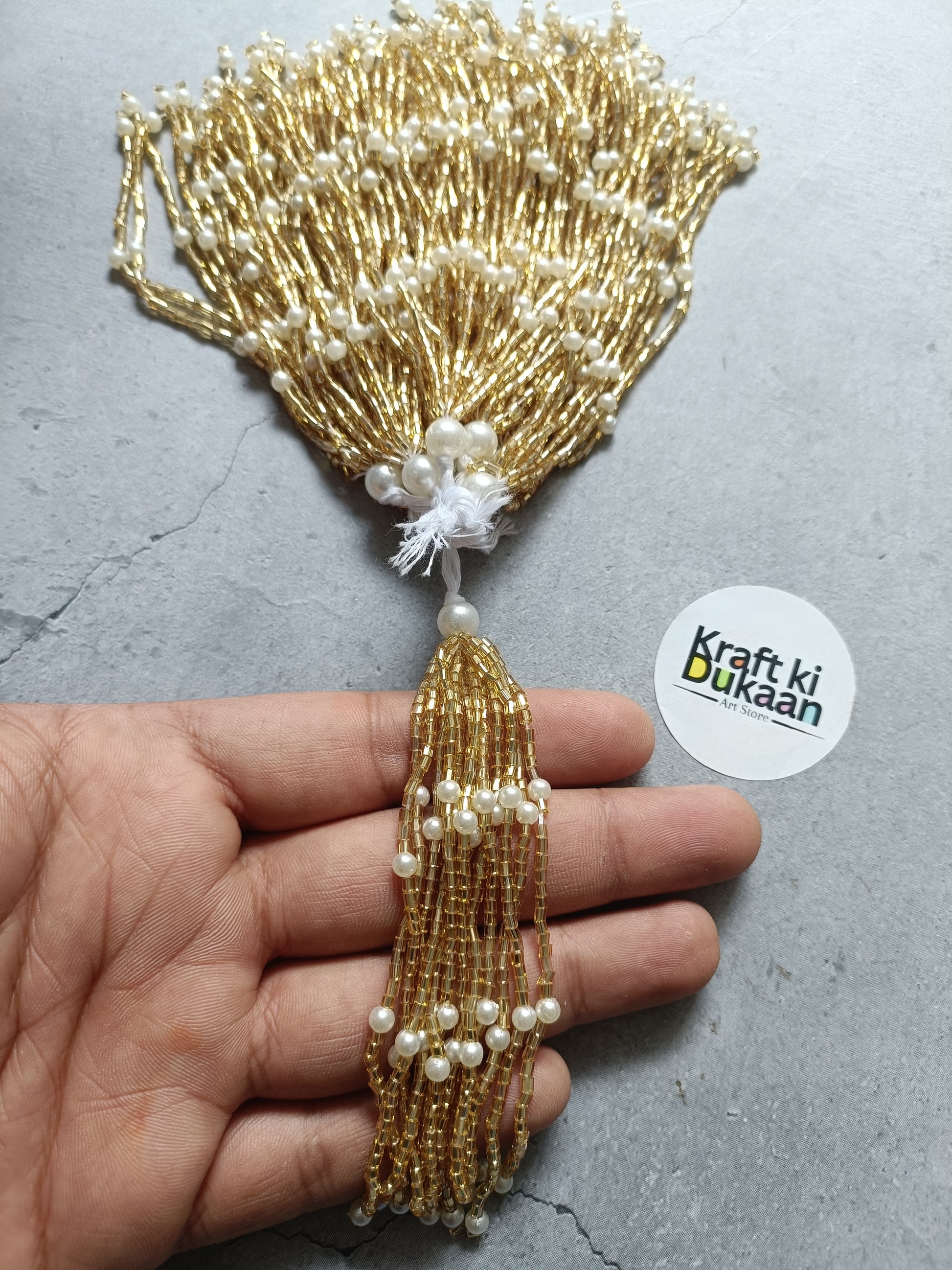 Gold beaded latkan tassel with pearl beads and white pom