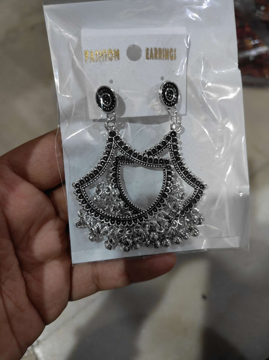 Silver jhumka-style drop earrings with black round tops and fan tassel design