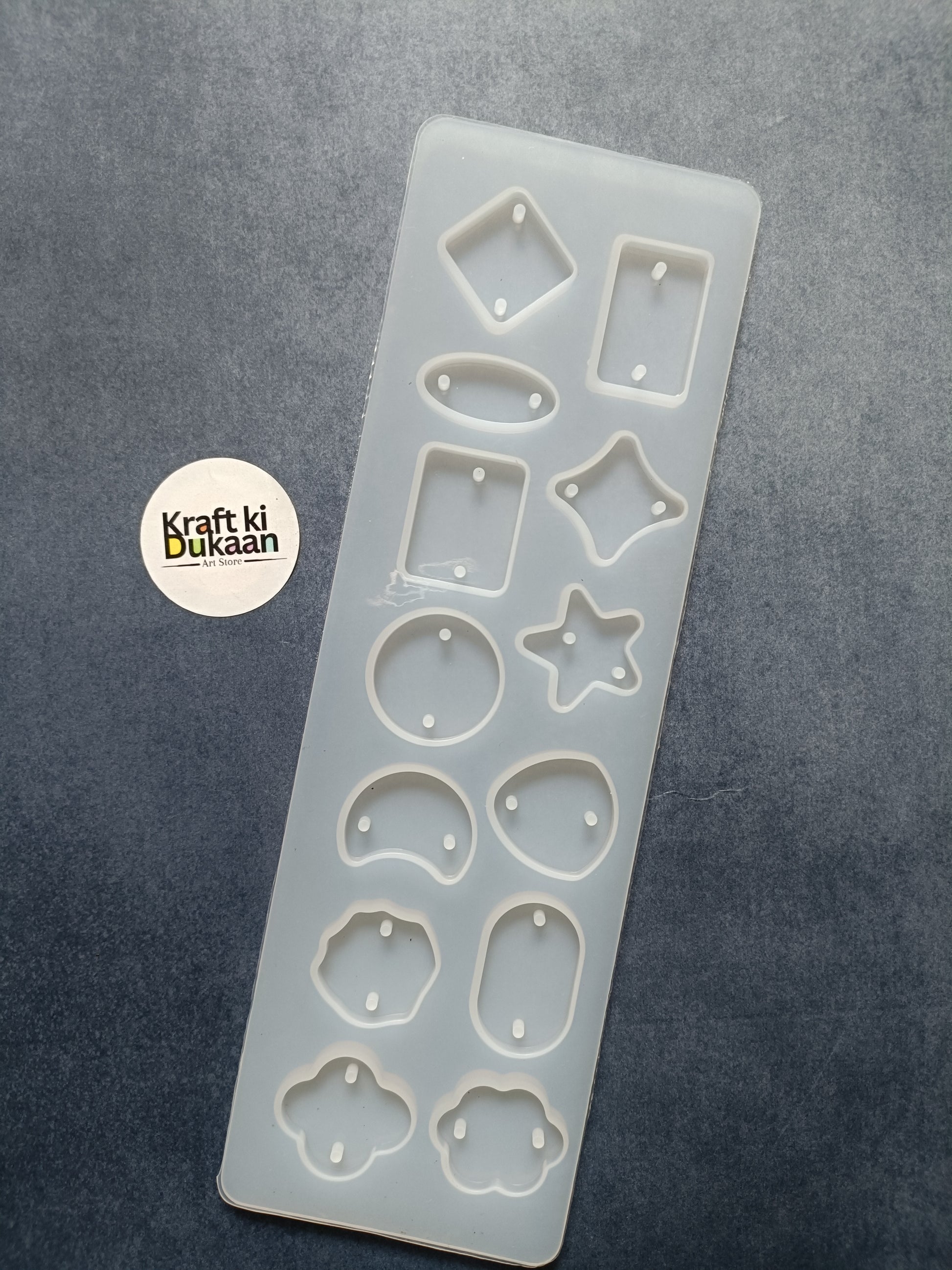 Rakhi mould with 12 cavities, light blue silicone insert with star, oval, and flower cavities