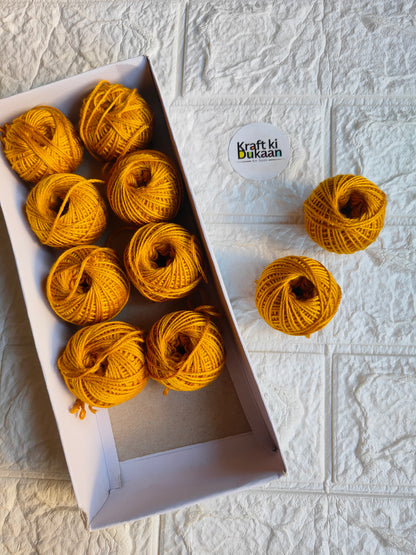 Rakhi thread roll with yellow-orange yarn balls and loose thread ends