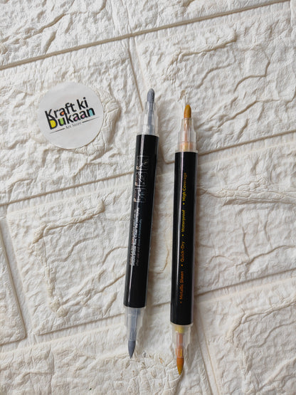 Dual-tip metallic acrylic markers with caps on, gold and silver tips visible