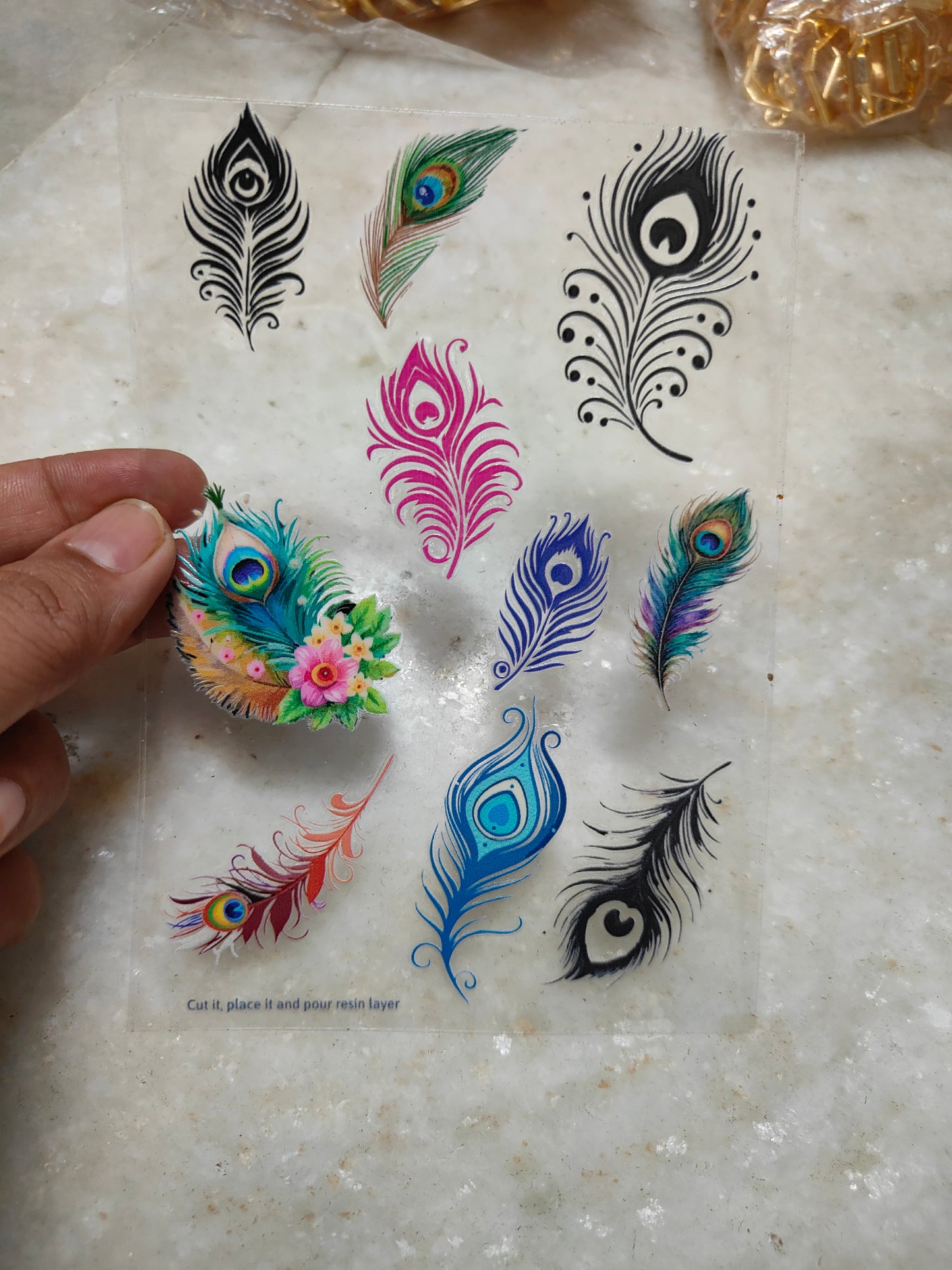 UV DTF peel-off sticker sheet with colorful feather and peacock eye designs