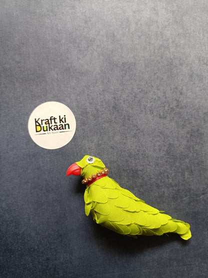 Green parrot figurine with red beak and jeweled collar