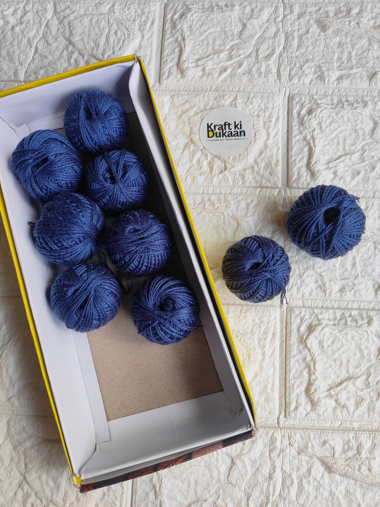 Rakhi thread spool set in dark navy blue, open box with multiple thread spools and spare spool