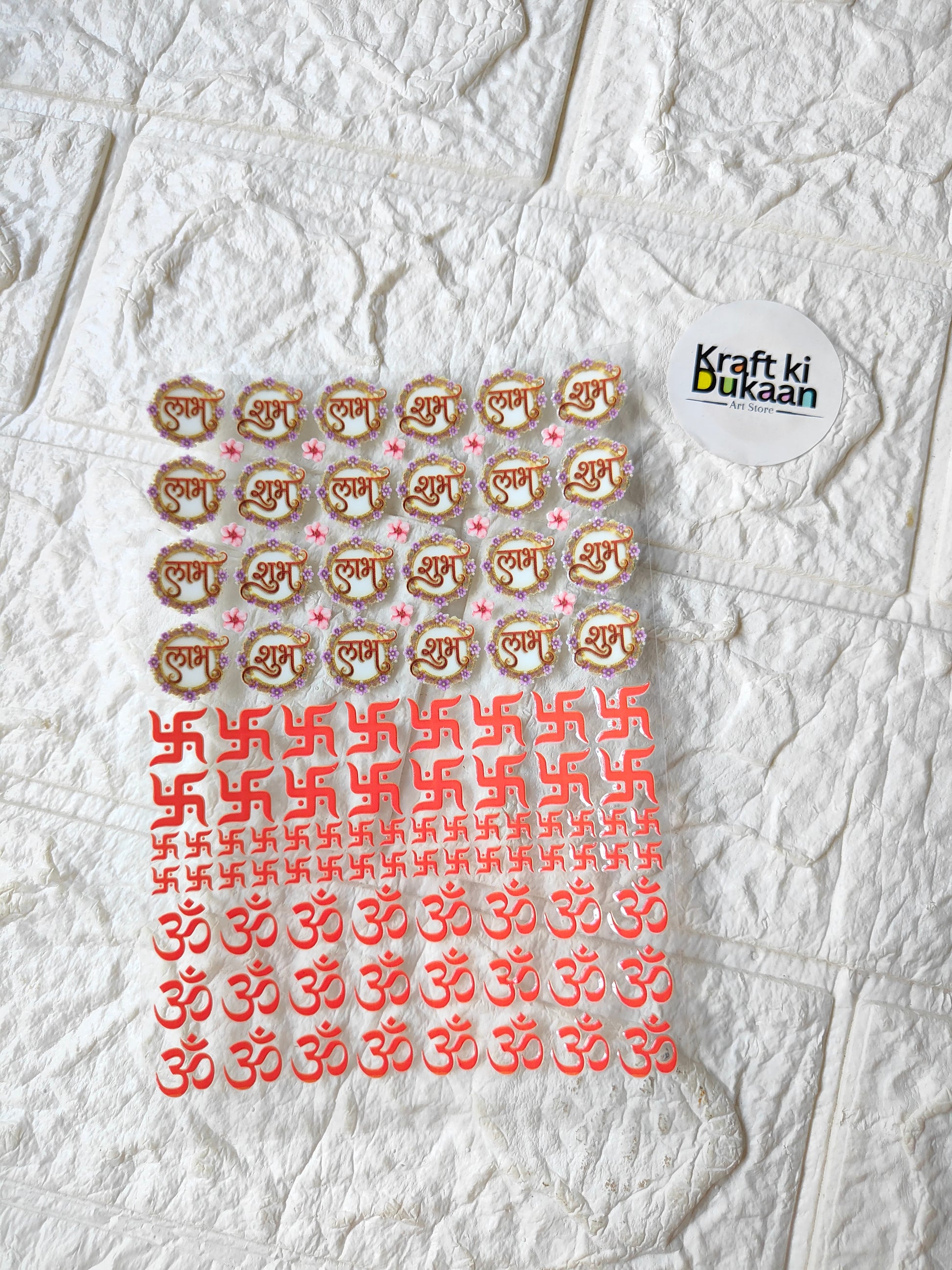 Peel-off sticker sheet with orange gold symbol prints and Kraft ki Dukaan logo