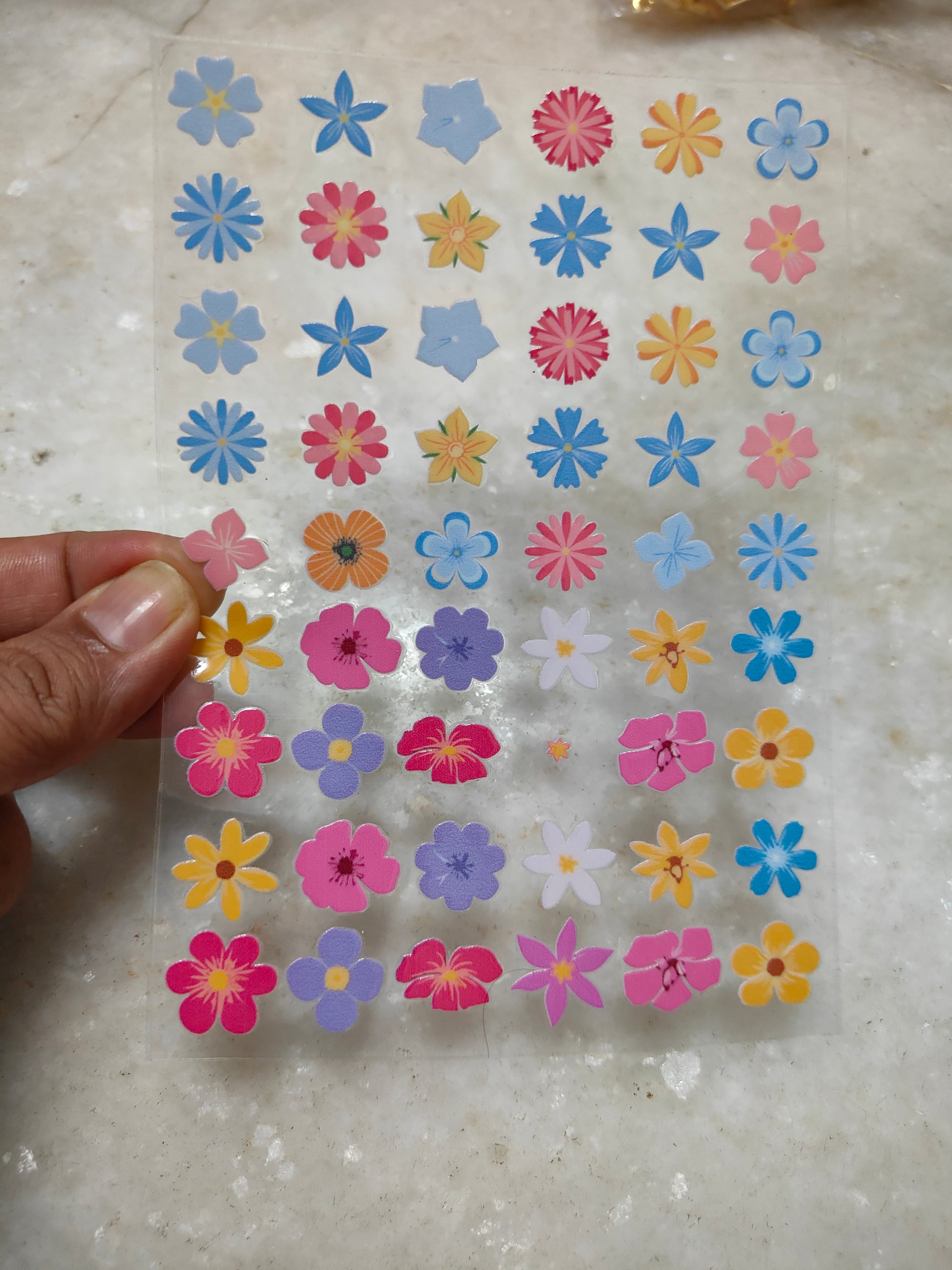 Peel-off sticker sheet with small multicolor flower decals