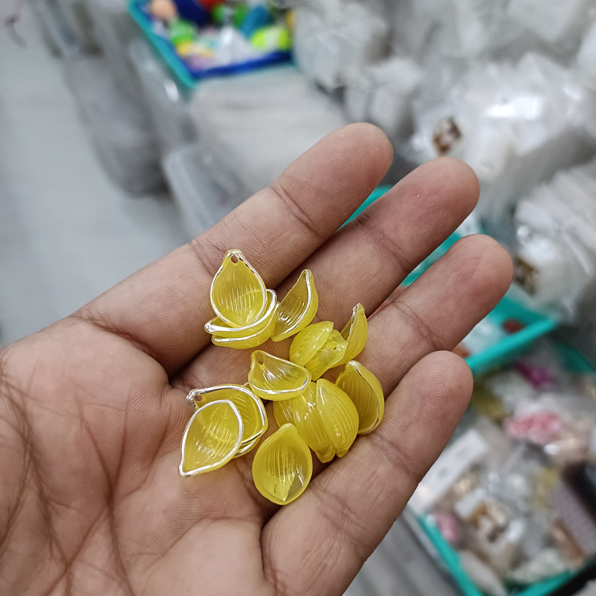 Acrylic petal beads, translucent yellow, assorted pieces in hand
