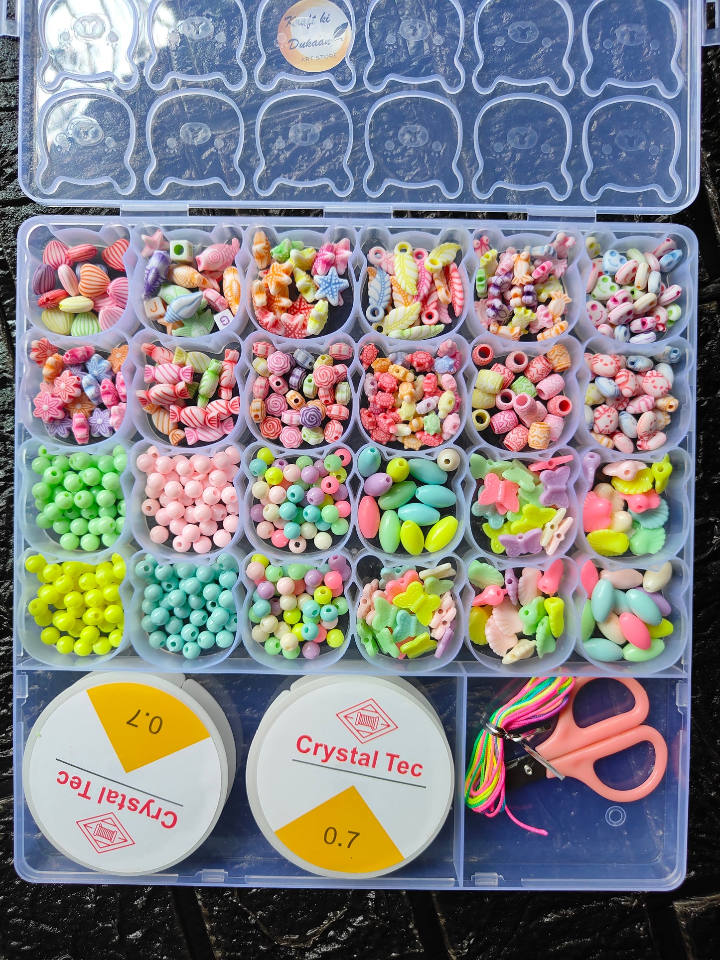 DIY bracelet beads kit A10: assorted pastel beads, star charms, and colorful cord in compartments
