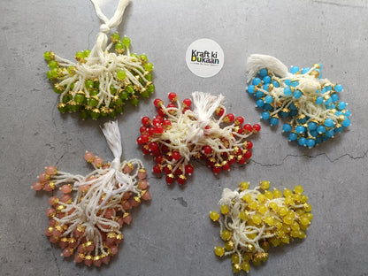 Set of bead-and-thread tassel latkans in green, red, blue, yellow, and peach