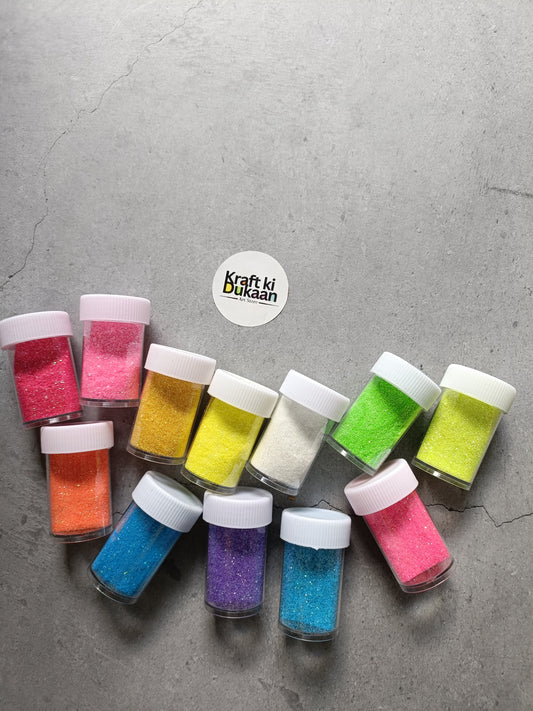Assorted neon glitter bottles with colored glitter and white caps