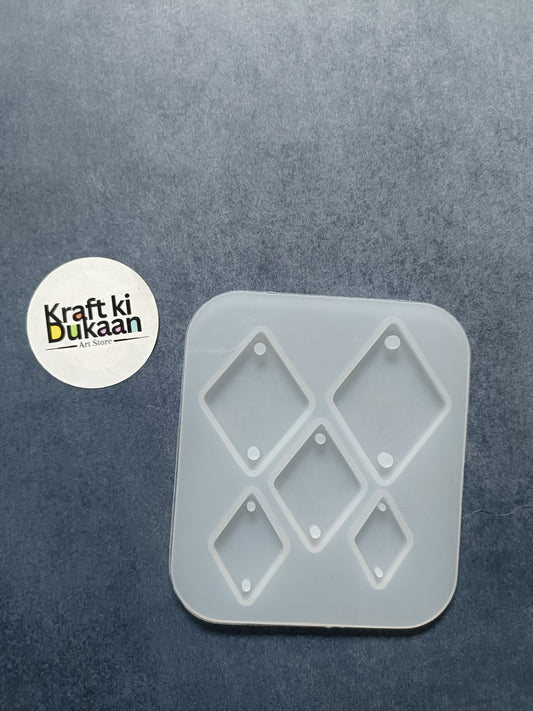 Kite rakhi mold with five kite-shaped cavities in light gray plastic