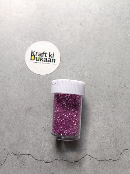 Purple pink chunky glitter powder jar with white lid.