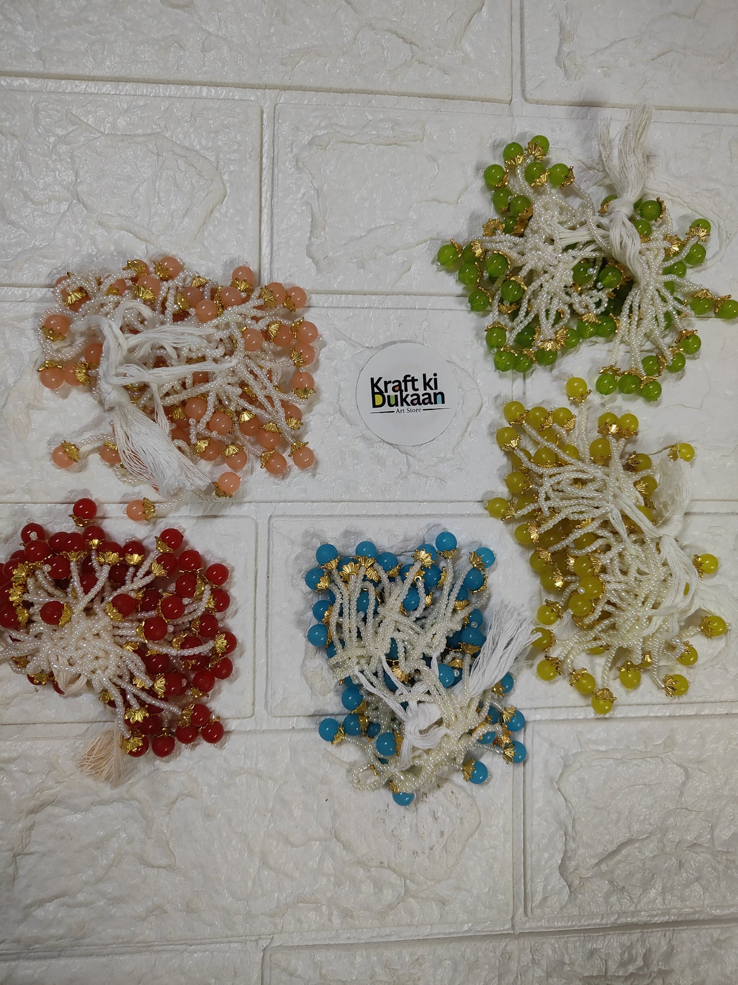 Set of beaded decorative tassels in white, green, blue, red, peach with gold beads
