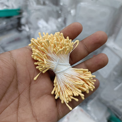 Artificial pollen bunch with light yellow bristle flowers tied with white string