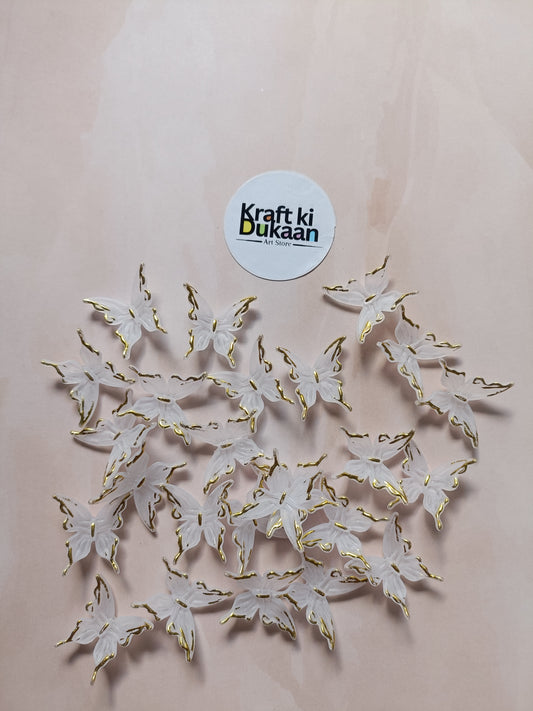 Butterfly bead pack of 25, gold-tone and white butterfly charms laid out