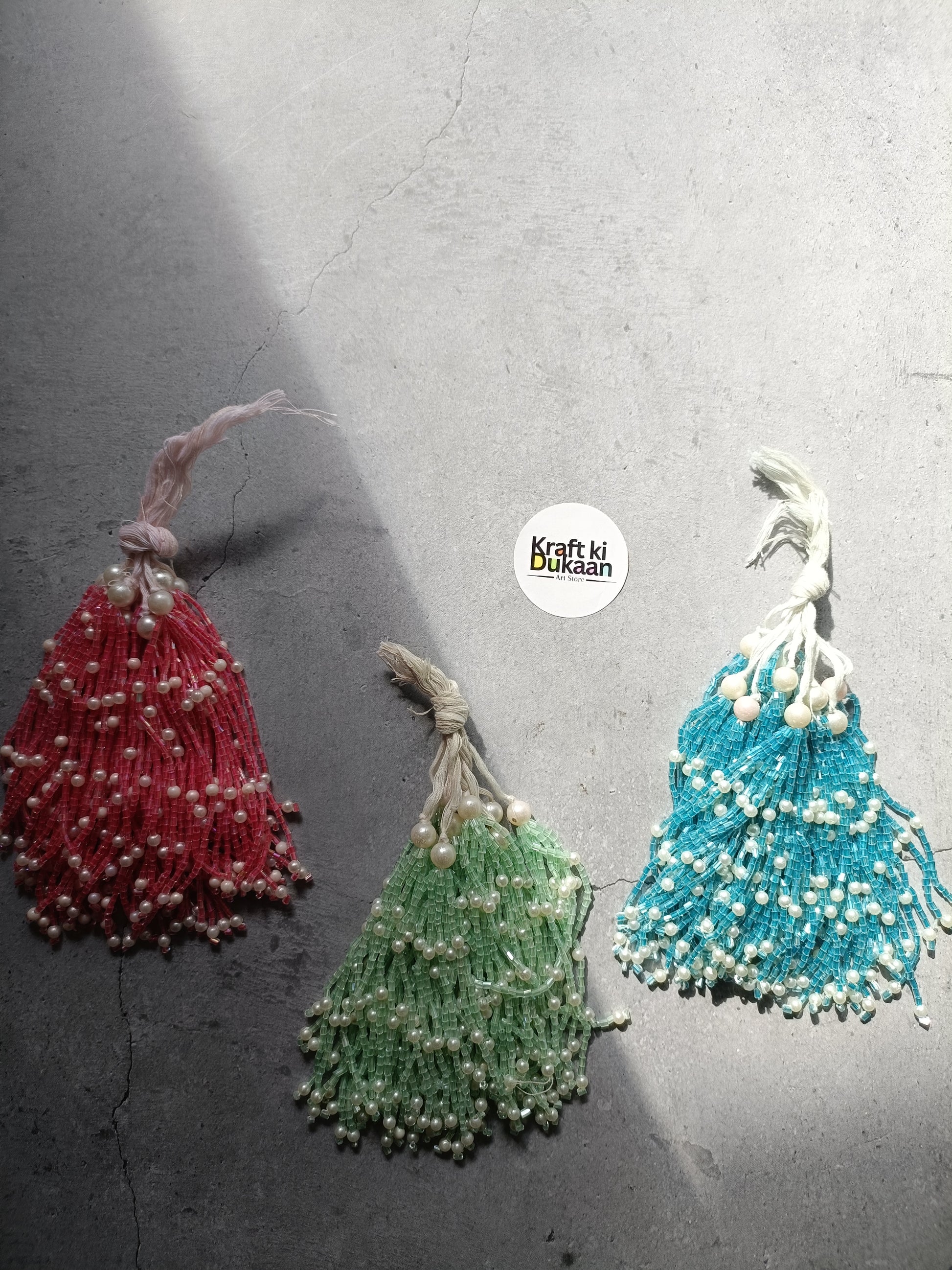 Beaded latkan set with red, green, and blue tassel charms