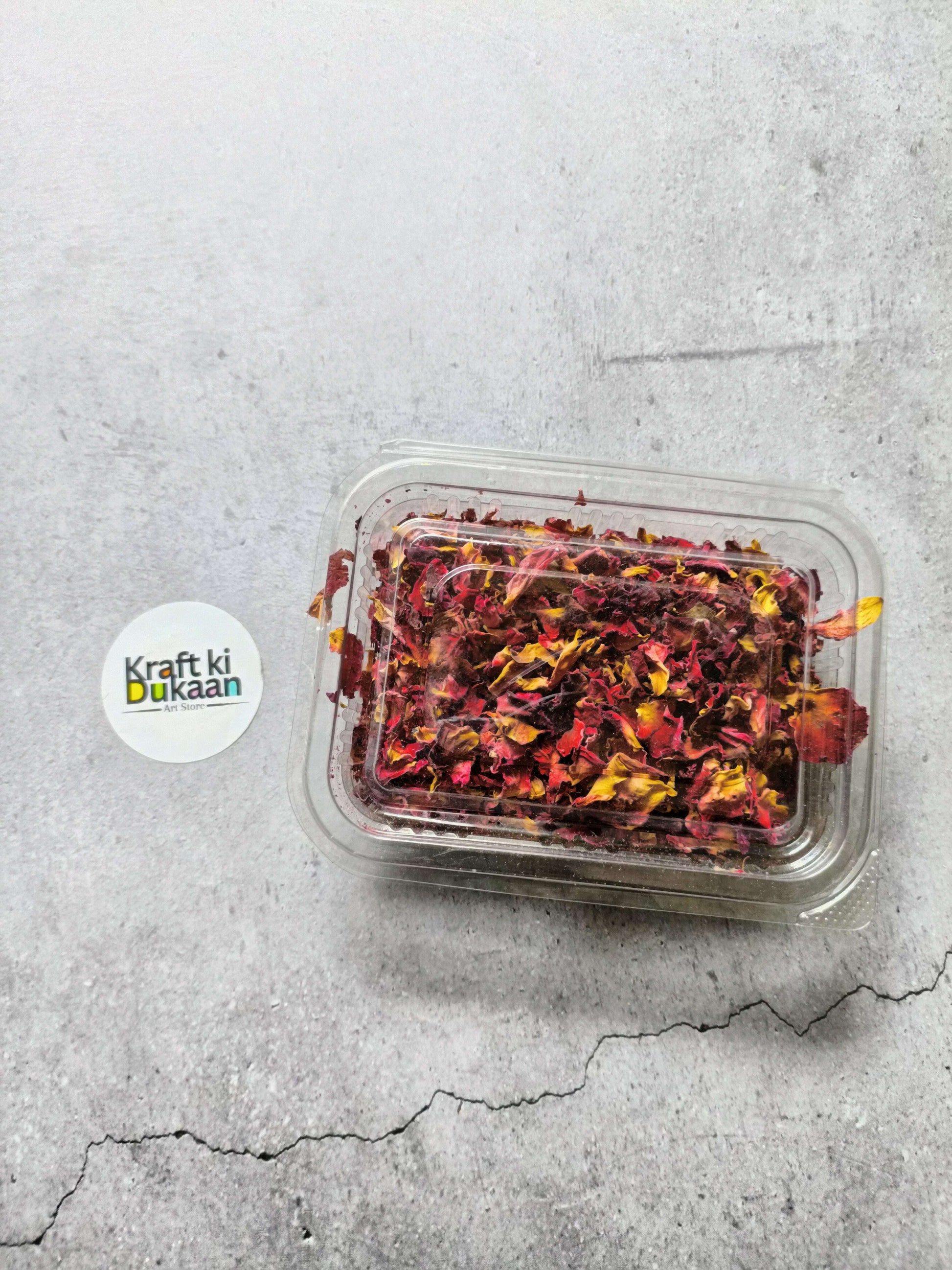 Clear plastic container of dried rose petals with snap lid