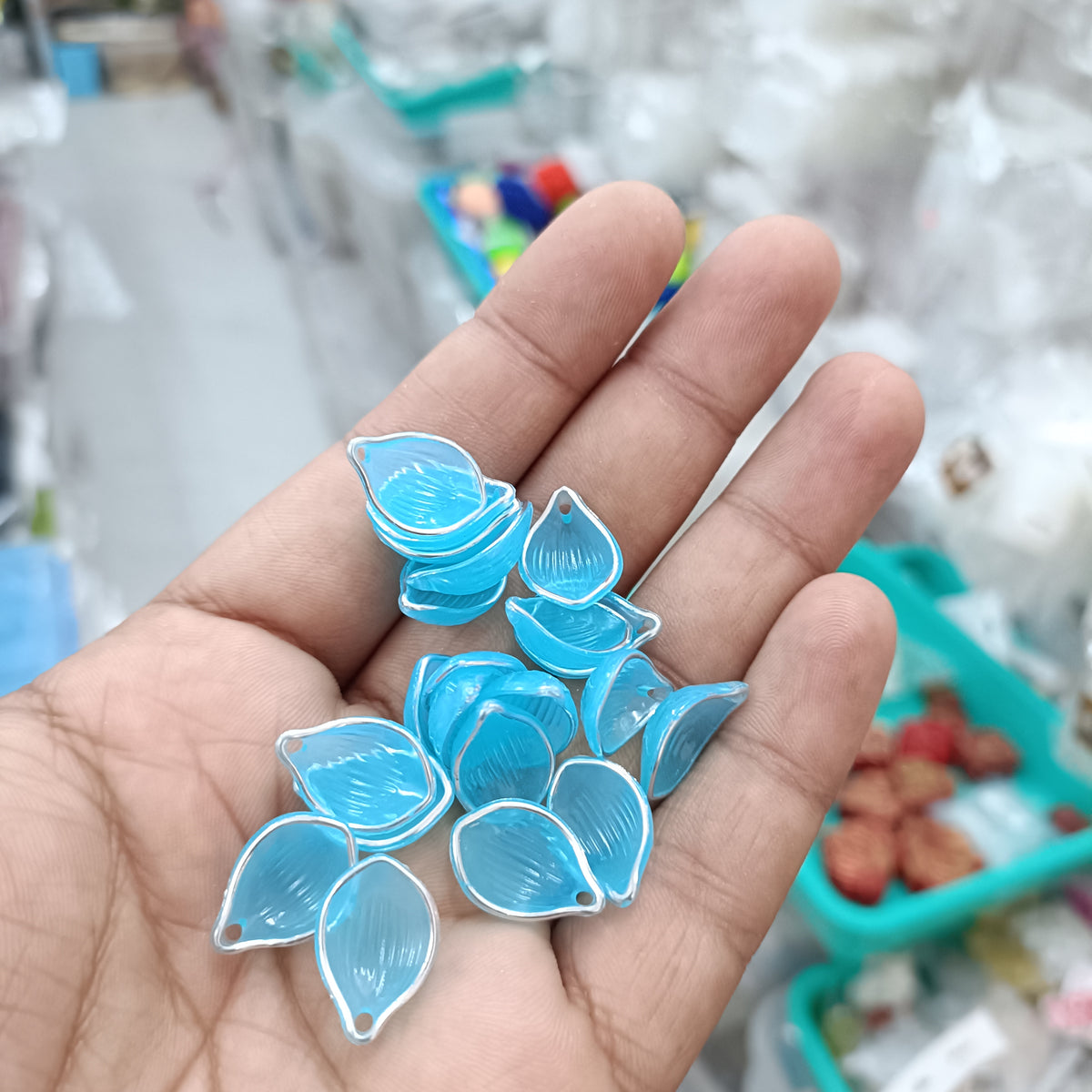 Acrylic petal beads, translucent light blue, assorted pieces in hand