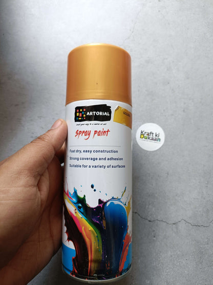 Golden spray paint can with colorful splatter artwork and “Kraft ki Dukaan” sticker