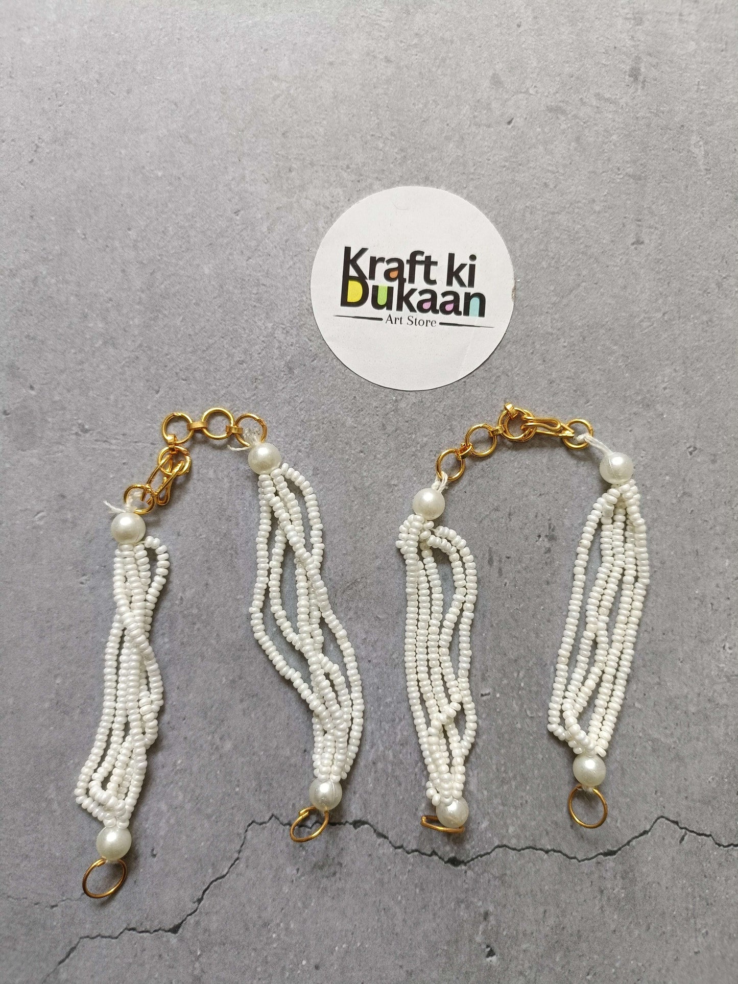 Gold link beaded bracelet with white pearl tassels and clasp rings, set of 5