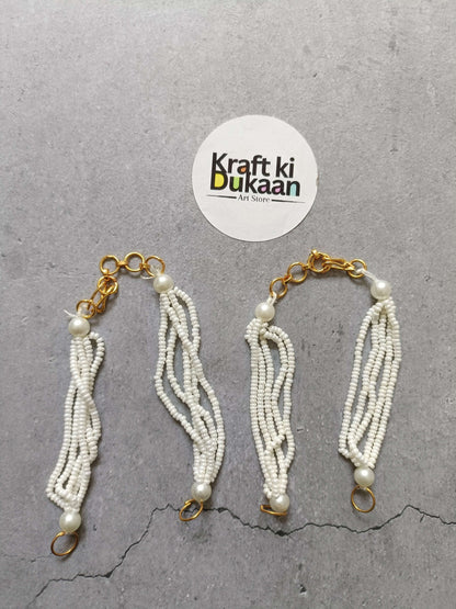 Gold link beaded bracelet with white pearl tassels and clasp rings, set of 5