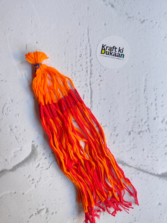Rakhi dori thread bundle with orange tassels and red striped strands