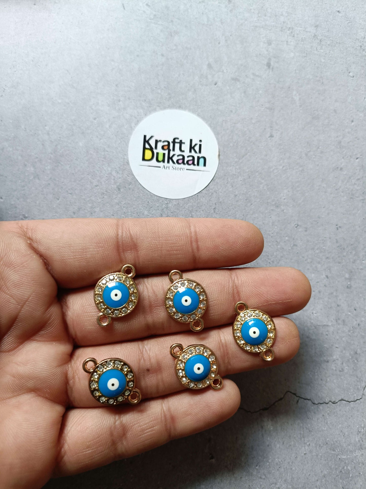 Gold-tone evil eye charm set (5), round blue cabochon with rhinestone border
