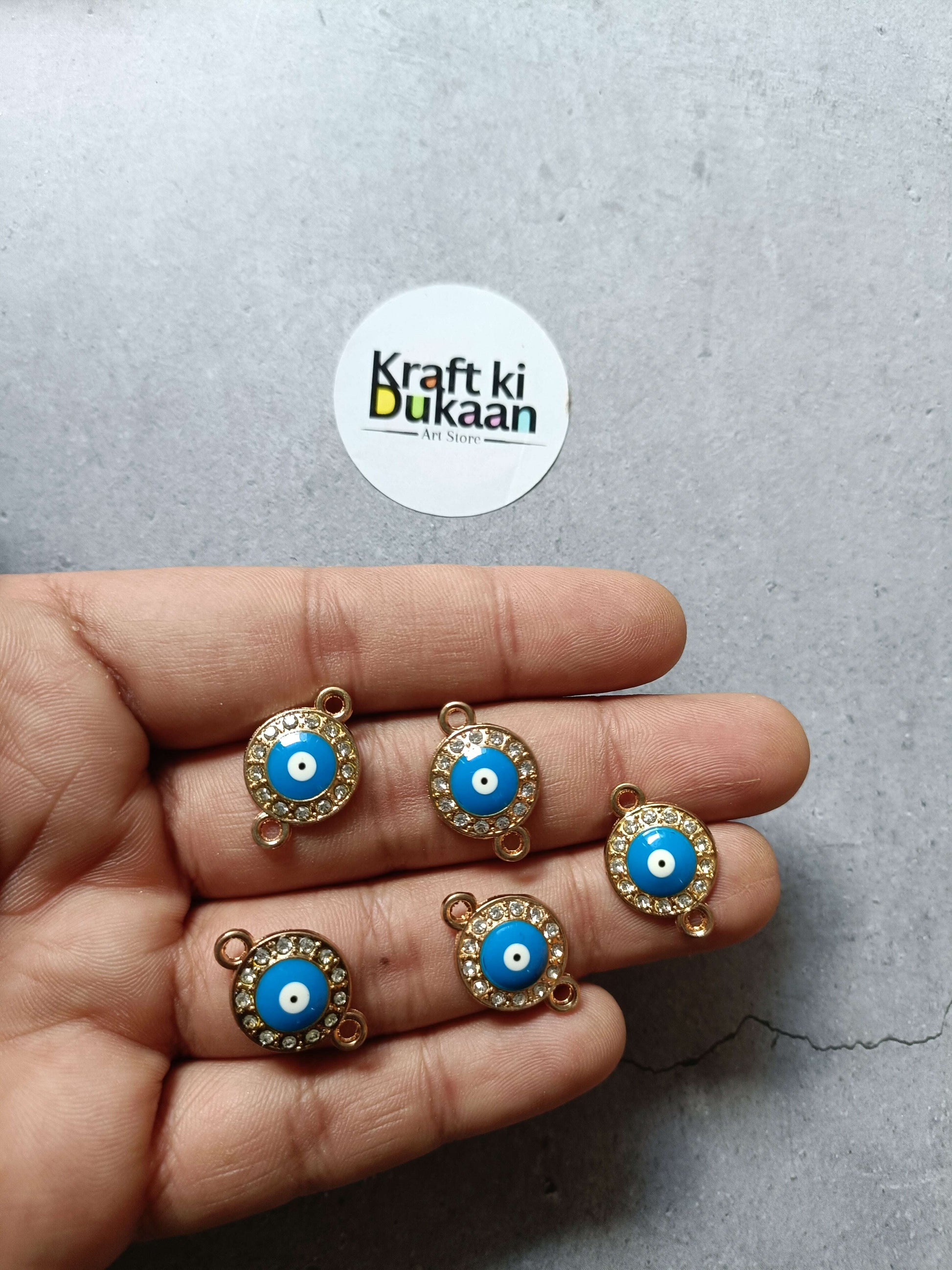 Gold-tone evil eye charm set (5), round blue cabochon with rhinestone border