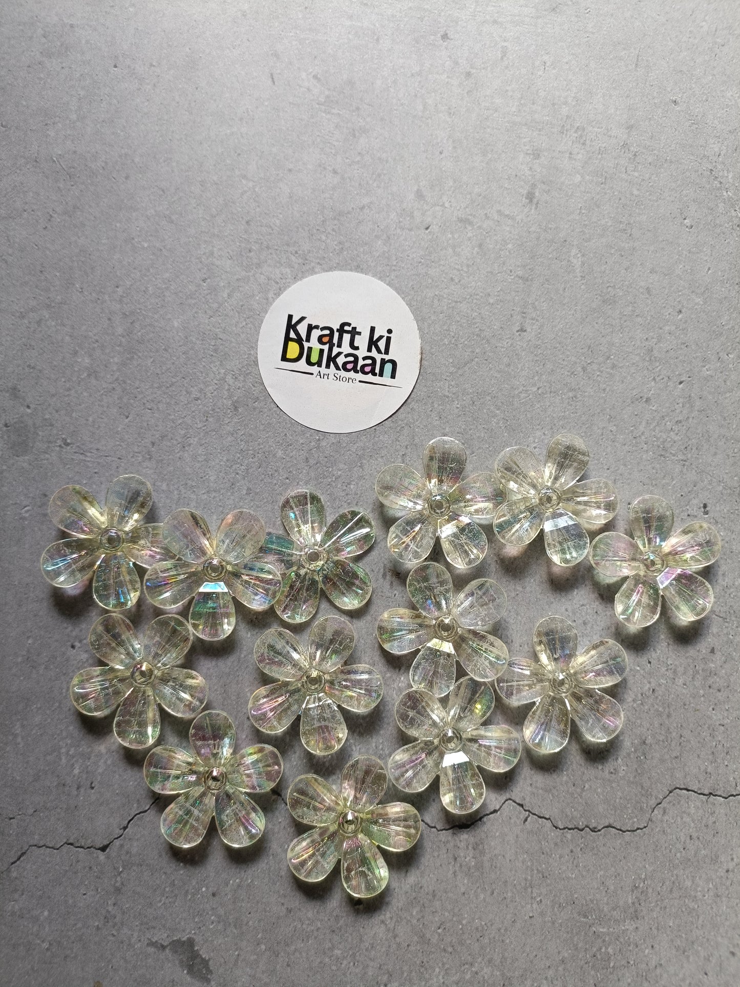 Rainbow flower beads pack laid out, clear iridescent 5-petal flower beads