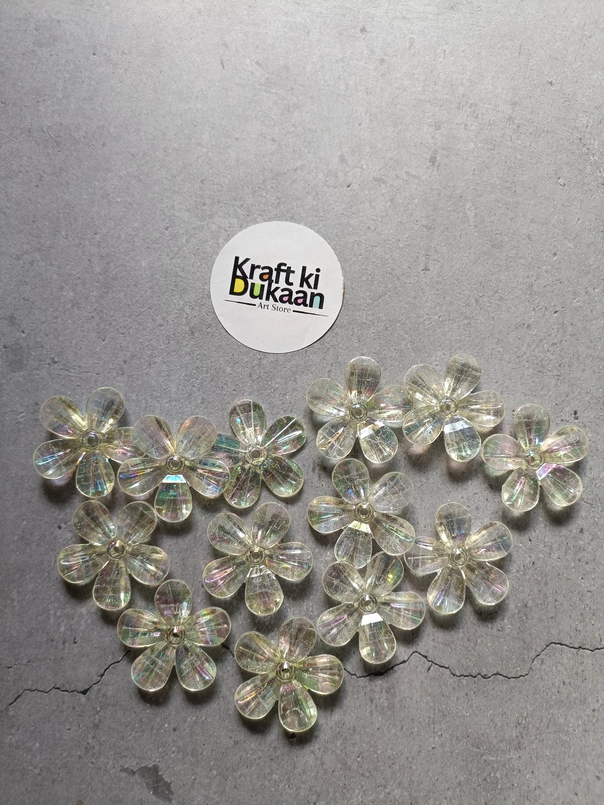 Rainbow flower beads pack laid out, clear iridescent 5-petal flower beads